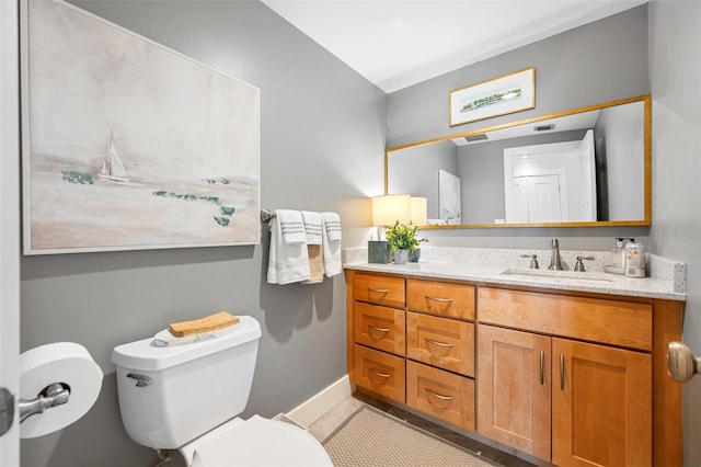 bathroom featuring vanity and toilet