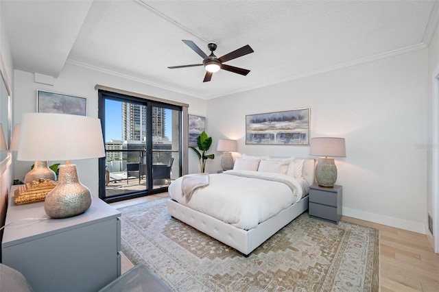 bedroom featuring hardwood / wood-style floors, ceiling fan, access to outside, a textured ceiling, and crown molding