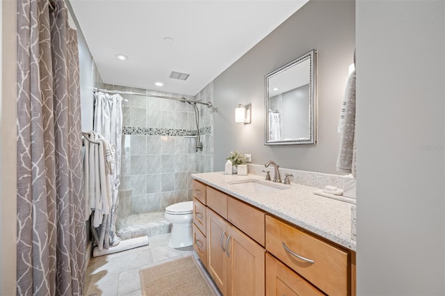 bathroom with vanity, curtained shower, toilet, and tile patterned floors