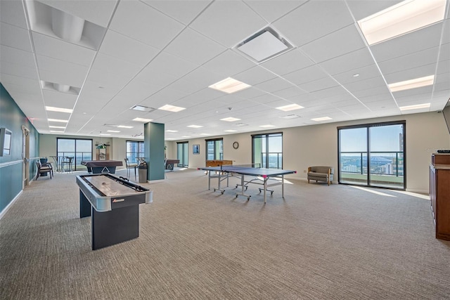 game room featuring carpet and a paneled ceiling