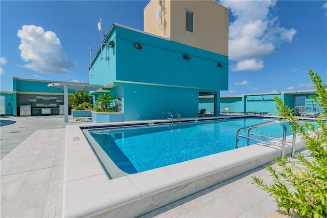 view of swimming pool featuring a patio and a pergola