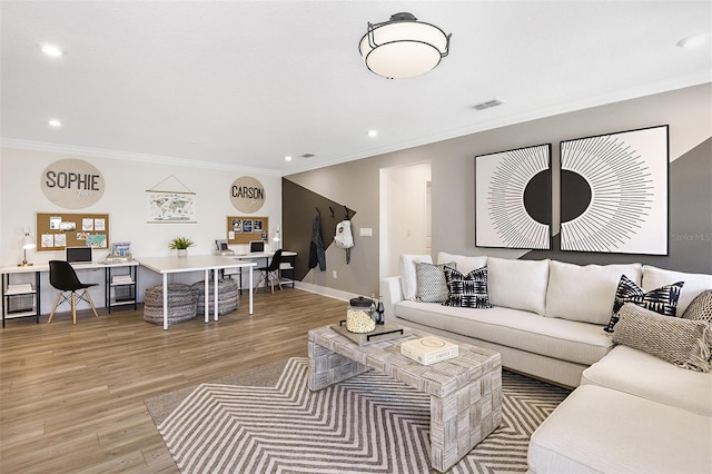 living room featuring crown molding and light wood-type flooring