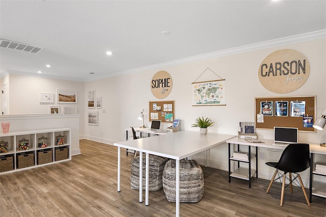 office space featuring crown molding and hardwood / wood-style floors