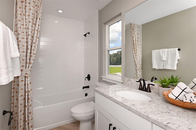 full bathroom featuring vanity, hardwood / wood-style flooring, toilet, and shower / tub combo