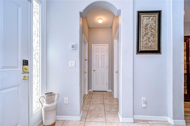 corridor featuring light tile patterned floors