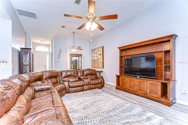 unfurnished living room featuring lofted ceiling, light hardwood / wood-style flooring, and ceiling fan