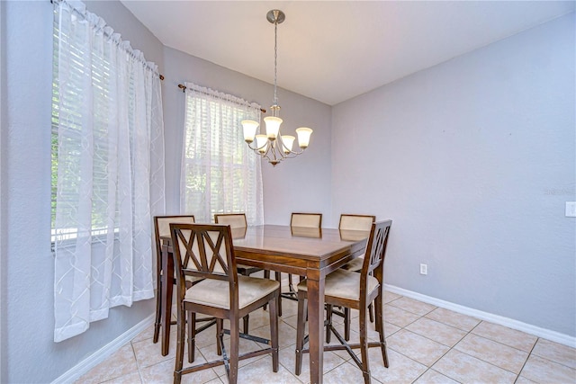 dining room with a chandelier and light tile patterned floors