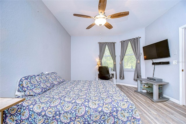 bedroom with wood-type flooring and ceiling fan