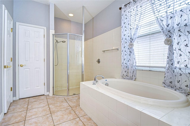 bathroom with plus walk in shower and tile patterned flooring