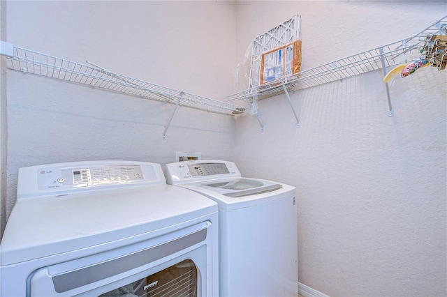 washroom with washing machine and clothes dryer