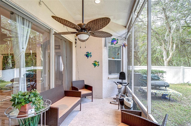 sunroom with ceiling fan and lofted ceiling