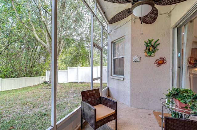 sunroom / solarium featuring ceiling fan