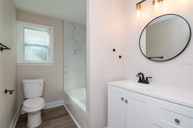 full bathroom featuring toilet, vanity, baseboards, and wood finished floors