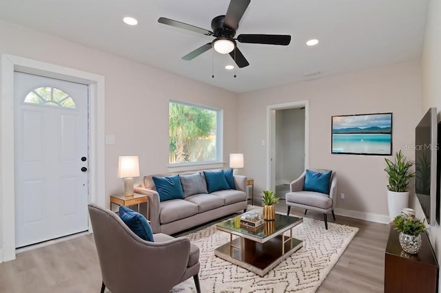 living room featuring a ceiling fan, baseboards, wood finished floors, and recessed lighting