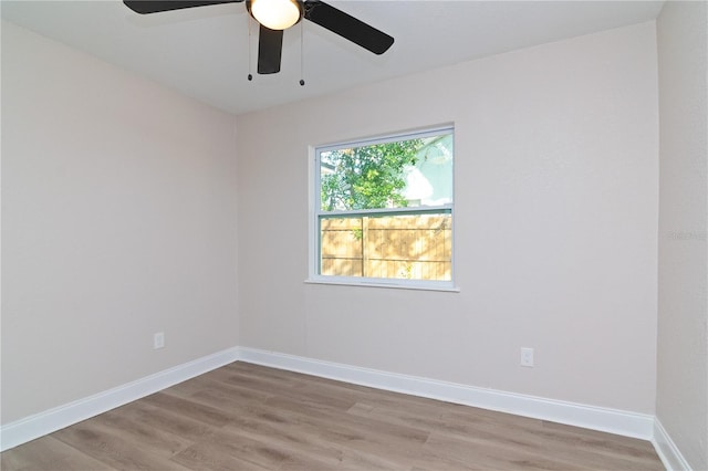 unfurnished room with baseboards and wood finished floors