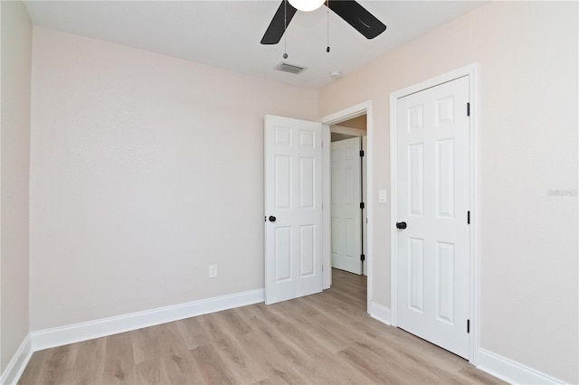 unfurnished bedroom featuring light wood-type flooring, visible vents, and baseboards