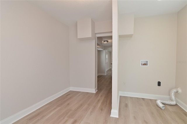 washroom featuring hookup for a washing machine, laundry area, light wood-style floors, and baseboards