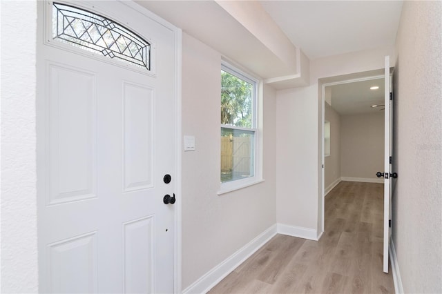 entryway featuring baseboards and light wood-style floors