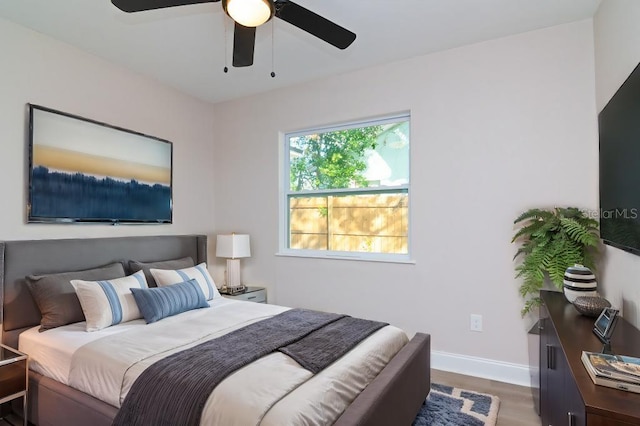 bedroom featuring a ceiling fan, dark wood finished floors, and baseboards