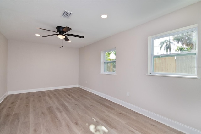 unfurnished room featuring light wood-style floors, recessed lighting, visible vents, and baseboards