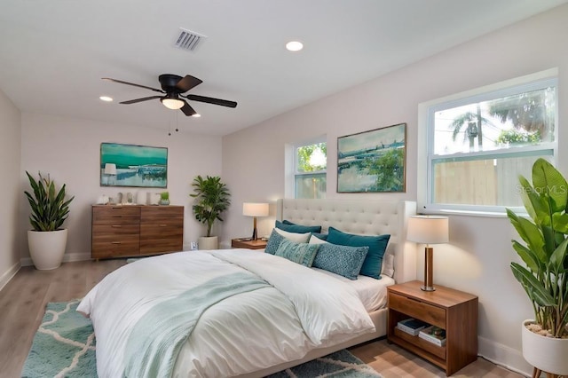 bedroom featuring multiple windows, visible vents, and recessed lighting