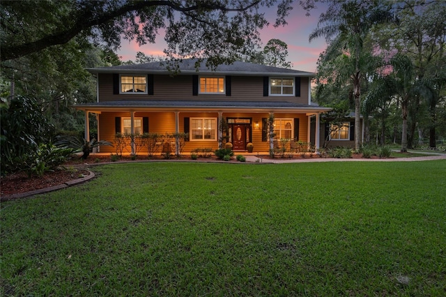 view of front facade with a yard and a porch