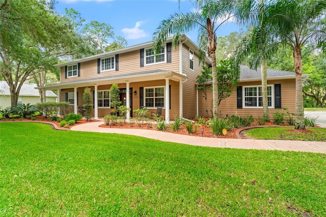 view of front of property with a porch and a front lawn