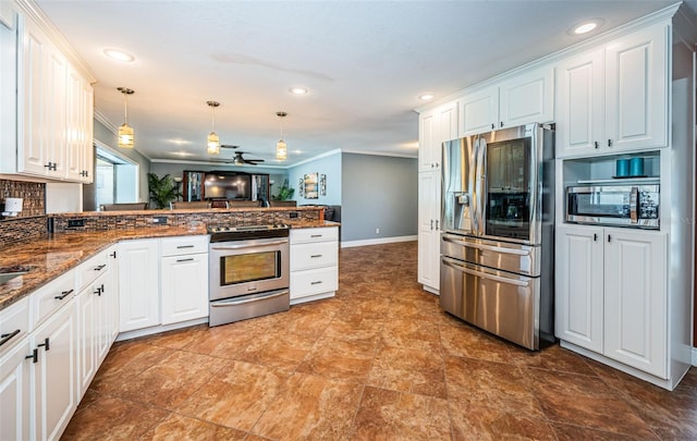 kitchen with kitchen peninsula, white cabinets, hanging light fixtures, appliances with stainless steel finishes, and dark stone countertops