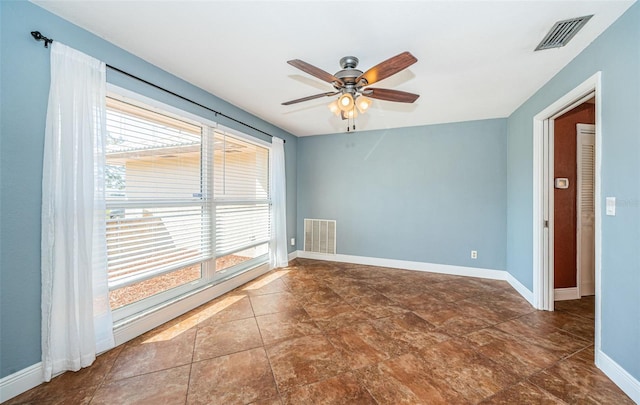 unfurnished room featuring plenty of natural light and ceiling fan