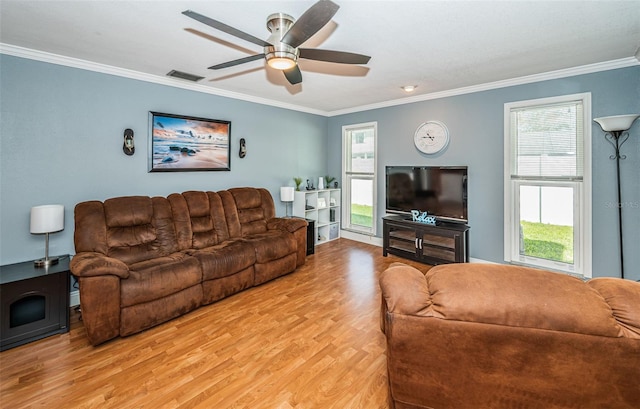 living room with crown molding, light hardwood / wood-style flooring, and ceiling fan