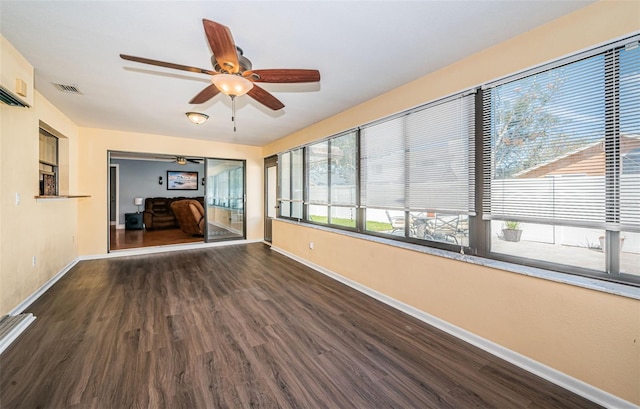 unfurnished room with dark wood-type flooring and ceiling fan