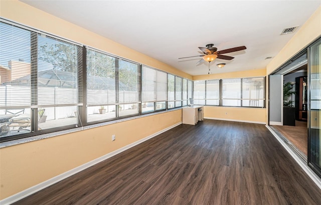 unfurnished sunroom with ceiling fan