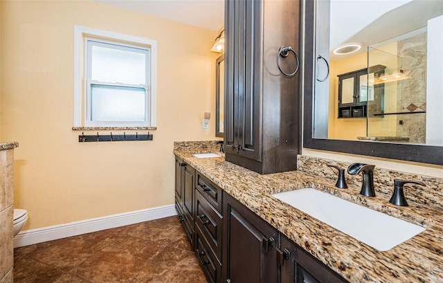 bathroom with vanity, toilet, and tile patterned floors