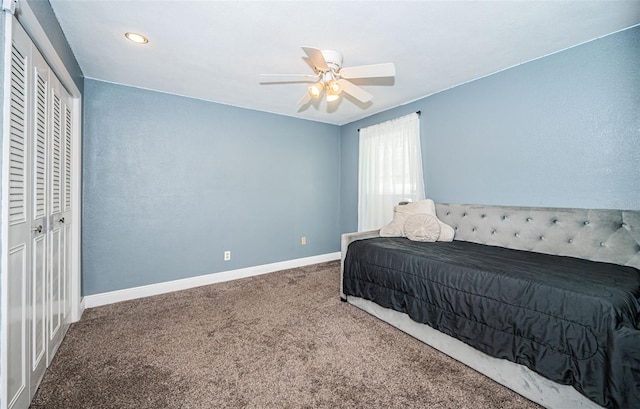 carpeted bedroom with a closet and ceiling fan