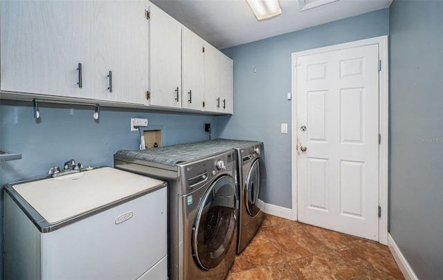 laundry room with sink, independent washer and dryer, and cabinets