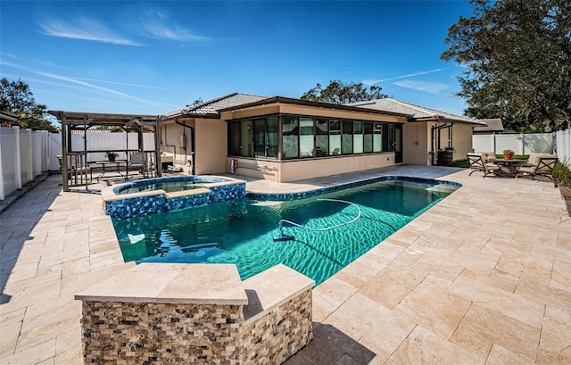 view of swimming pool featuring an in ground hot tub and a patio area