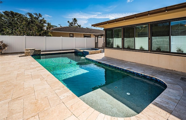 view of swimming pool featuring an in ground hot tub and a patio