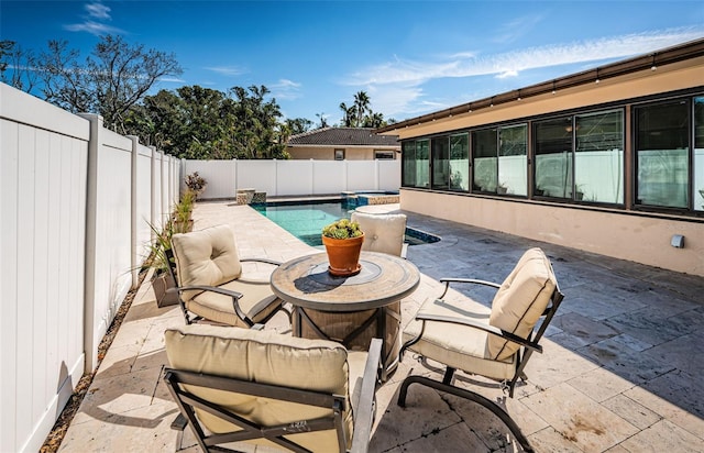 view of patio with a fenced in pool