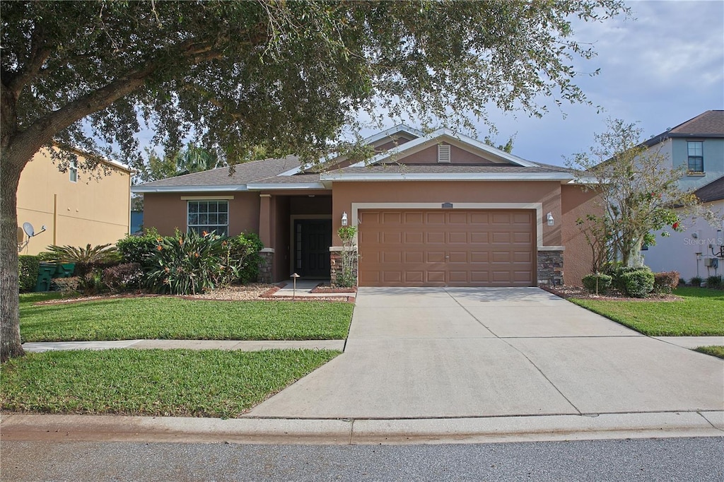 view of front of house with a front lawn and a garage