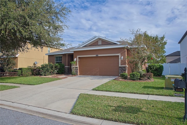 view of front of property featuring a garage and a front lawn