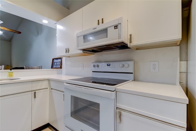 kitchen featuring white appliances, white cabinetry, and sink