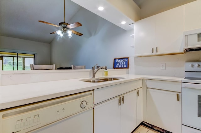 kitchen with white appliances, sink, lofted ceiling, white cabinets, and light tile patterned floors