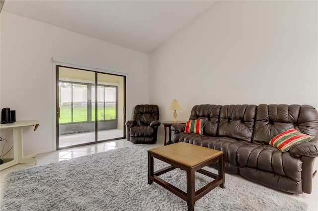 tiled living room featuring vaulted ceiling