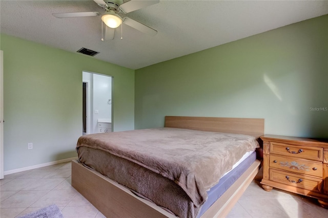 bedroom featuring connected bathroom, light tile patterned floors, and ceiling fan