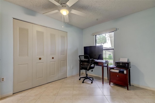 office area with a textured ceiling, light tile patterned floors, and ceiling fan