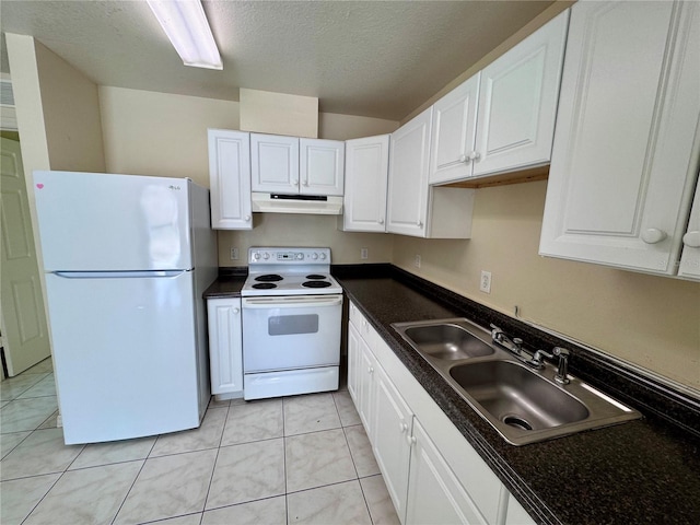 kitchen featuring sink, light tile patterned flooring, white cabinets, a textured ceiling, and white appliances