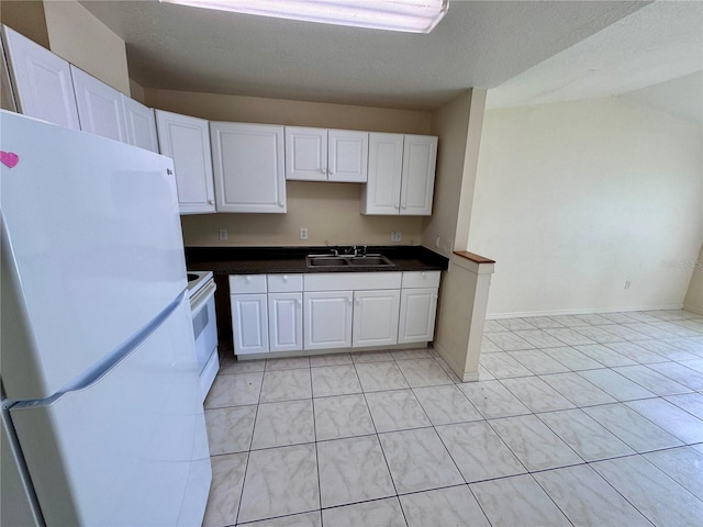 kitchen featuring sink, white cabinetry, a textured ceiling, and white appliances