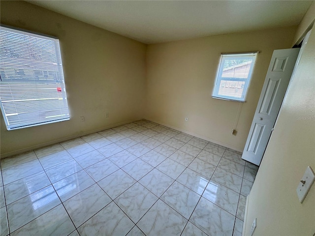 empty room with light tile patterned floors