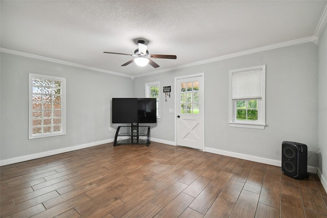 unfurnished living room featuring a textured ceiling, ornamental molding, and ceiling fan