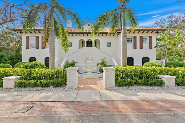 mediterranean / spanish-style home featuring a tile roof and stucco siding